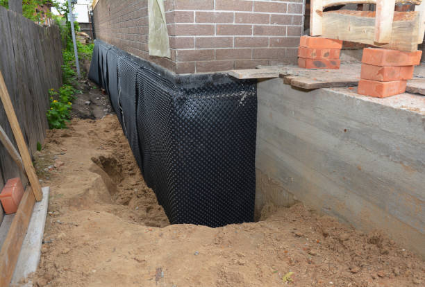 SJ Waterproofing Pros technician performing targeted Wet Basement Repair assessment in Java Center, NY